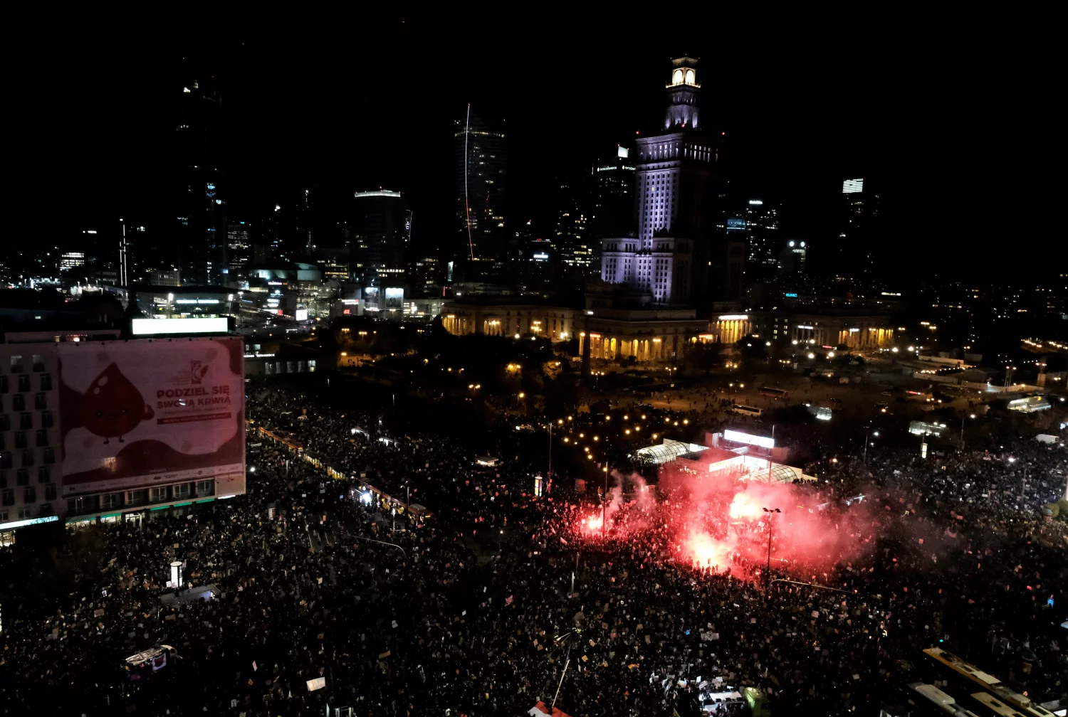 Drone view - Tens of thousands of people protest in the streets of Warsaw at night against the court verdict.